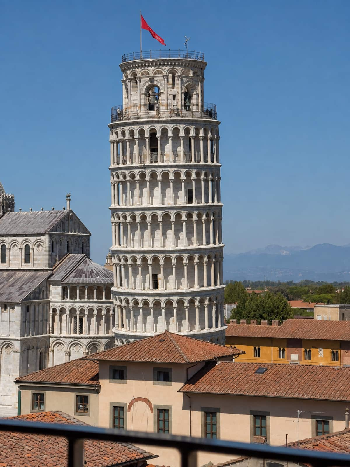 The Leaning Tower and cathedral above the rooftops of Pisa